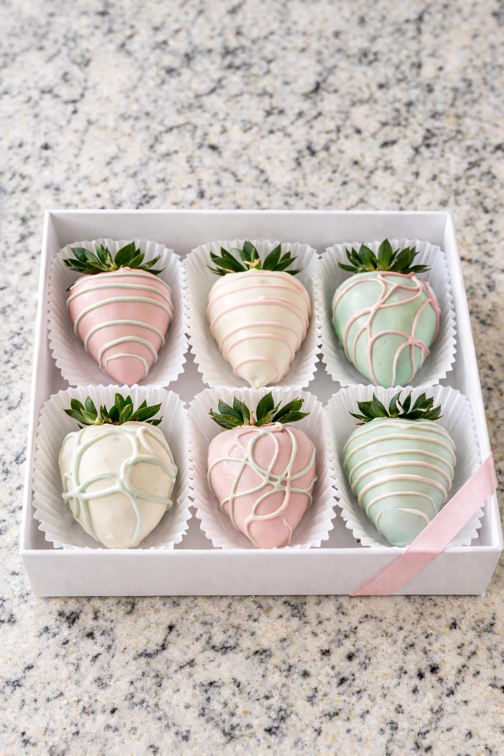 Realistic Grand Magnolia gift box with exactly 6 chocolate covered strawberries